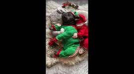 French Bulldog and newborn is sleeping in the cutest christmas outfits.