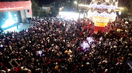 Palestinians gather during the Christmas tree lighting in the West Bank