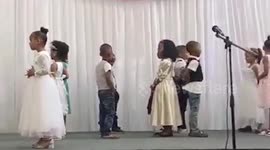 Kind stranger runs onstage to dance with little girl when classmate abandons her in front of audience