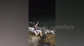 Clumsy tourist slips on wet seaside stairway in the Philippines