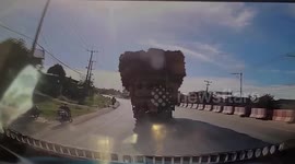 Hay bales topple from truck onto oncoming car