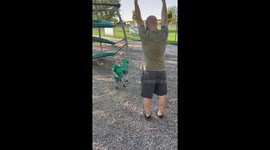 Adorable 2 y/o twins can't stop laughing at their dad working out at the playground