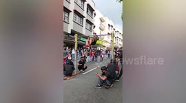 Fitness coach catches himself from falling while doing stunts during exhibition