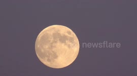 The December full Moon also known as the  cold moon rises over East London
