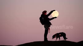 Woman 'holds' last full moon of year at Arbor Low Stone Circle, England
