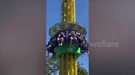 Tourist does her makeup while strapped into fairground ride