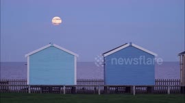 Stunning full Cold Moon seen rising above beach in Kent, UK