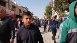 Palestinian mourners carry the bodies of three Palestinians killed by Israeli forces in a raid in the West Bank city of Jenin, during their funeral in the refugee camp of the same name