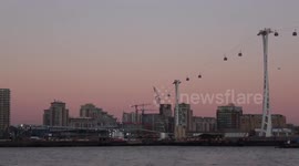 The December Full Moon known as the Cold Moon rises over city hall in London's Docklands