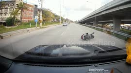 Bungling motorcycle rider using his phone is hit by car at junction in Thailand