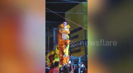 Lion dance performer breaks collarbone after missing jump in front of audience in Thailand