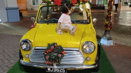 Adorable toddler on 'Christmas Decorated Antique Car'