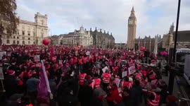 Thosands of striking Royal Mail workers stage rally outside British parliament