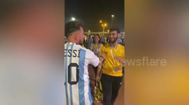 Argentina fan tries to see wherever an Australian will accept a Lionel Messi shirt at the World Cup