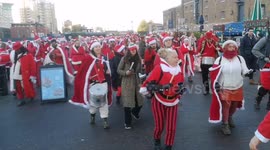 Ho-ho-ho! Dozens dress as Father Christmas for London's Santacon