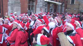 Hundreds of Santas arrive at Liverpool Street station during SantaCon London 2022