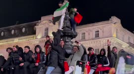Morocco fans IGNORE protection barrier and climb Eros statue in London