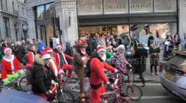 100's of cyclists is santa costumes ride through Regent Street