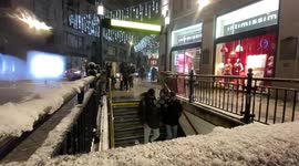 Snow falls in London’s West End as temperatures plummet