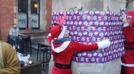 Some Santa's try to wrap up Liverpool Street Station during the annual Santacon