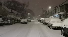 Snow falls on the streets of Woodford in East London on Sunday night
