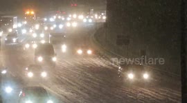 Snow causes causes slow-moving traffic on London's North Circular Road