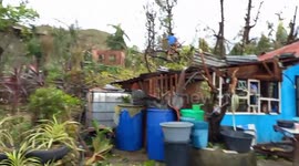 Resident survey damage left by powerful typhoon in the Philippines