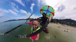 Heartwarming moment disabled woman flies on parasail on Thai beach