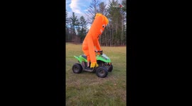 Wacky Inflatable dude riding a Quad Bike tries to pop a Wheelie!
