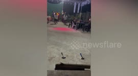 Workers race to hammer nail into wood in unique Christmas party game
