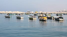 Palestinian artist Ahmed Bakr, 13, draws paintings at the Gaza seaport
