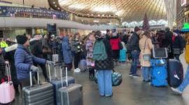 Passengers wait at London's King's Cross station after train cancellations