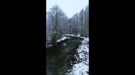 Artic Blast Aftermath: Drone shot steadily flys up the river Coln, next to Ampney Crucis, Gloucestershire.