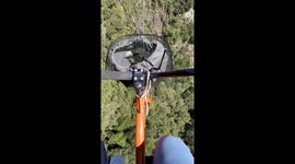 Woman embraces her adventurous side by riding a bicycle on a zipline 150m above the ground!
