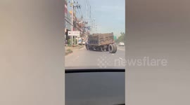 Hilarious moment truck driver chases after dislodged wheel rolling down road