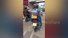 Motorcyclists travel with massive yellow snake in pet carrier
