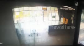 Dramatic footage shows truck crashing into office building, nearly toppling people