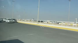 English soccer fan fascinated by roadside camel racing while leaving Qatar, World Cup
