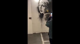 Activists poured cream on a copy of the Banksy painting