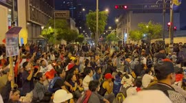 Riot police fire tear gas at protestors sat in the road in Lima