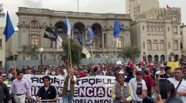 Protestors march through Lima’s central square to protest the arrest of President Castillo