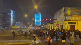 Protesters march along Lima’s Av Miguel Grau as police attempt to control them