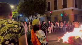 Protesters light fires in the middle of the street in Lima, Peru