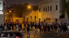 Protesters in Lima confront police in Plaza San Martín. Police eventually respond by firing tear gas and charging at them