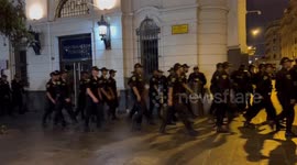 Hundreds of police marching through Lima’s Plaza San Martín after multiple nights of disorder in the city