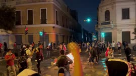Burning barricades block the street in central Lima as protestors chant