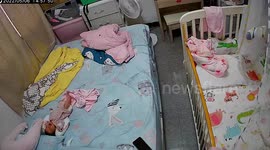 Caring pet beagle comforts crying infant that woke from sleep