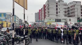 Police fire tear gas as protesters try to push past them during protests in Lima Peru