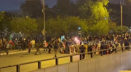 Protesters with homemade riot shields face off against police in Lima, Peru