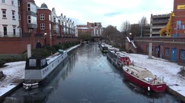 Beautiful sunrise over canal boats which have been frozen in Birmingham as sub-zero temperatures continue to bite the UK